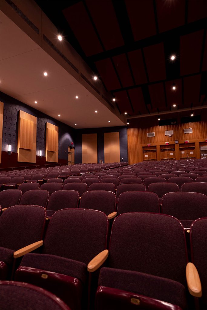 After view of Penn’s Grove Middle School auditorium with RETRO-installed house lights and stage curtains visible