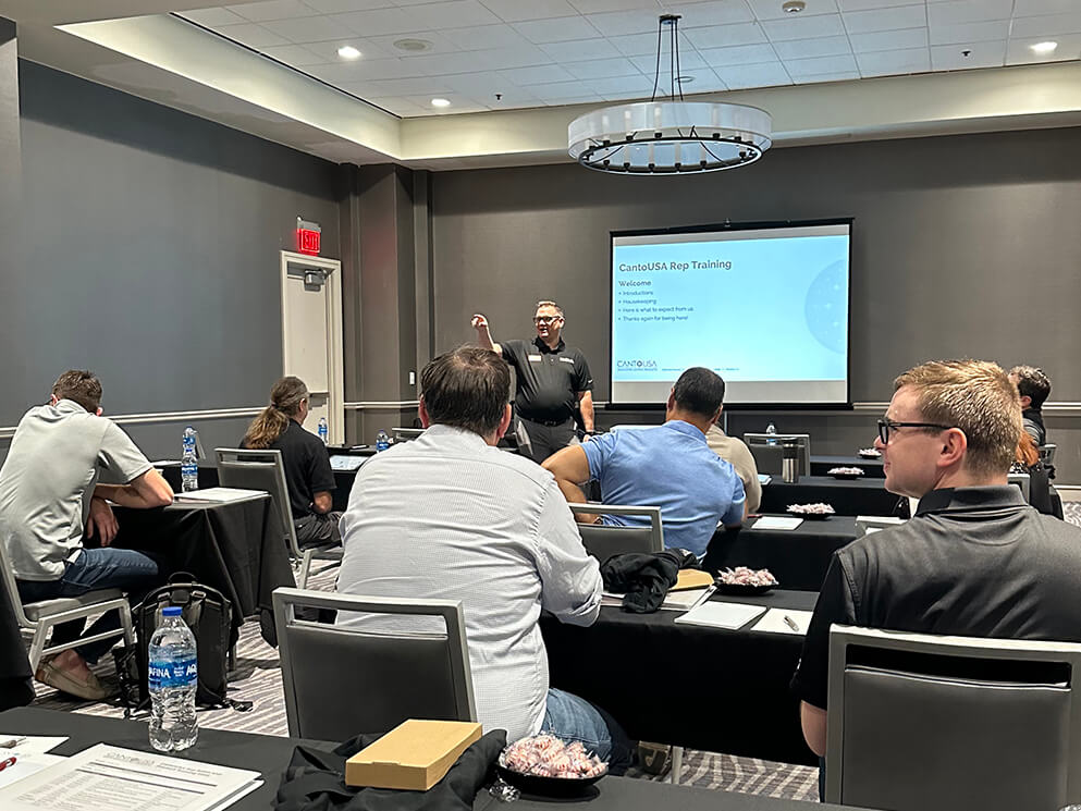Sales representatives listening to a presentation during a Canto USA training session