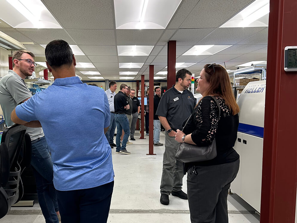 Attendees talking during a Canto USA factory tour